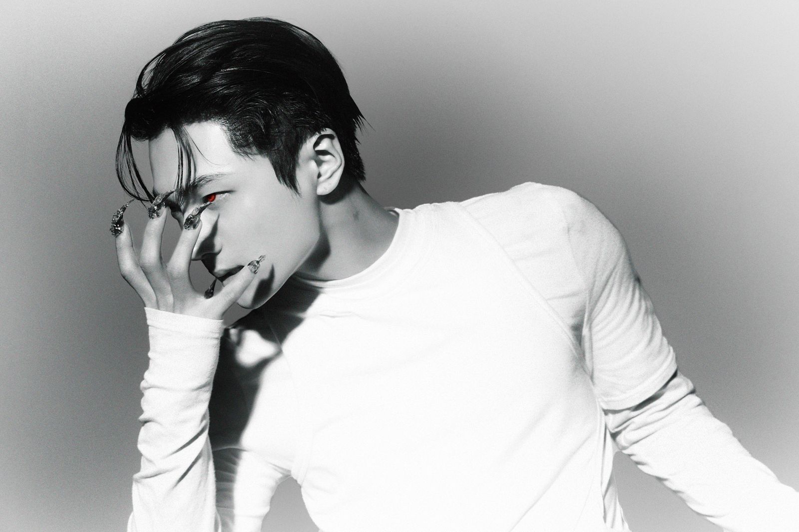 a man in a white shirt smoking a cigarette