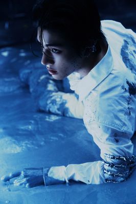 a woman in a white shirt and silver bracelets