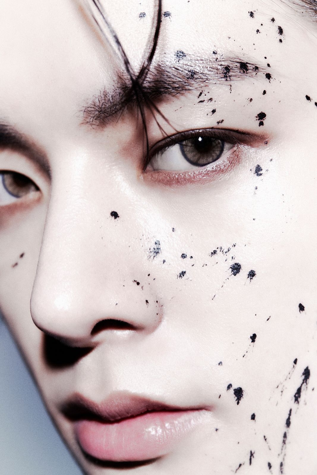 a close up of a person with black spots on his face