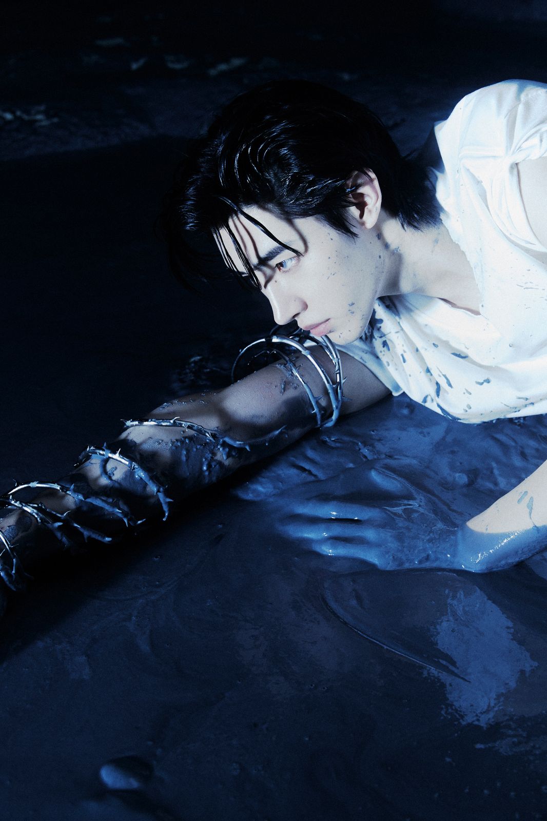 a woman laying on the ground with a knife in her hand