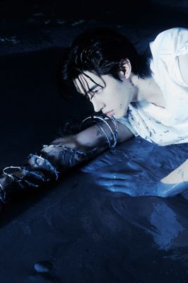 a woman laying on the ground with a knife in her hand