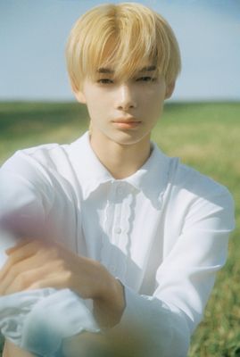 a young man in a white shirt posing for a picture