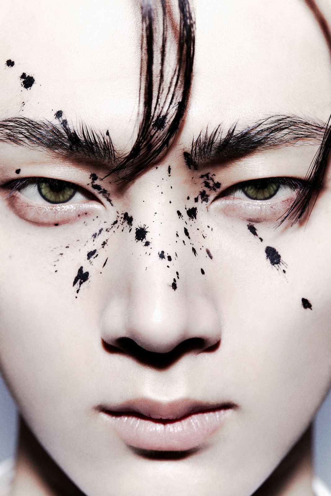 a close up of a person's face with hair and makeup