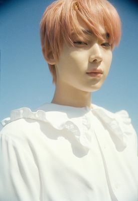 a man with pink hair wearing a white shirt