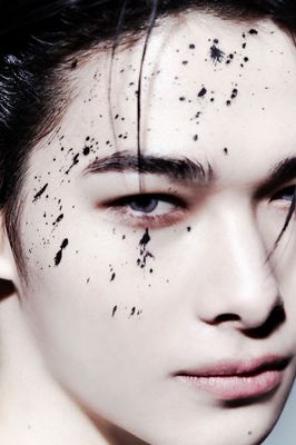 a man with black spots on his face