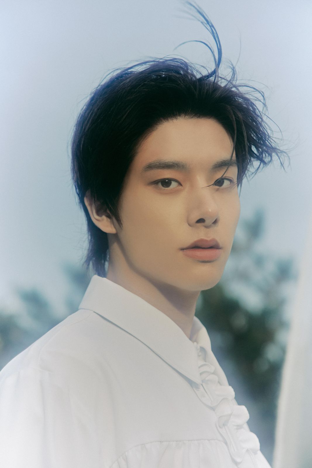 a man with black hair and a white shirt