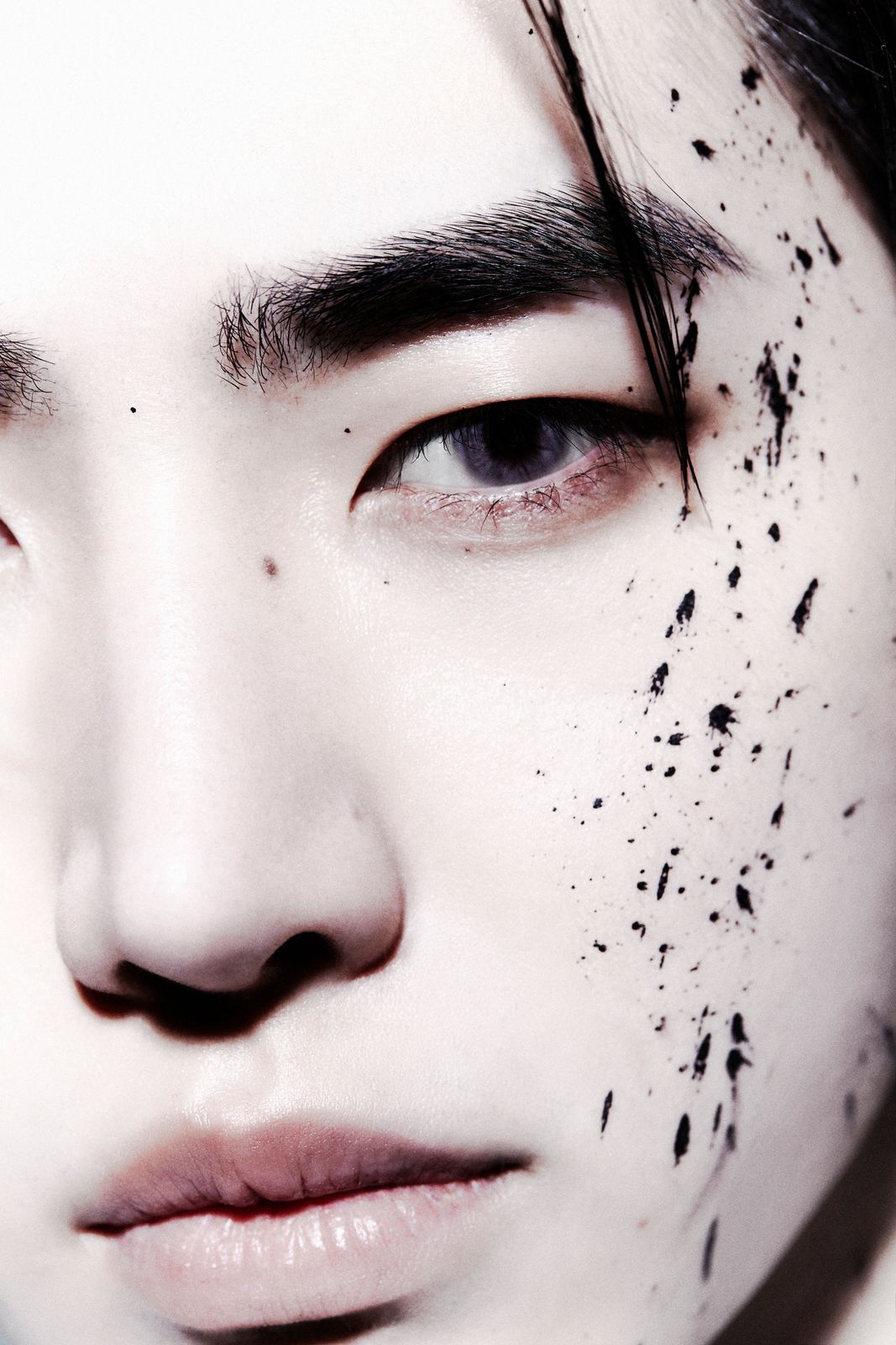 a close up of a person with black spots on his face