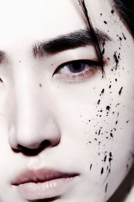 a close up of a person with black spots on his face
