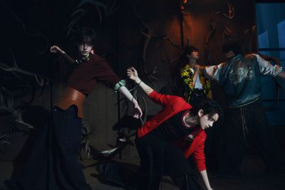 a group of people dancing in a dark room