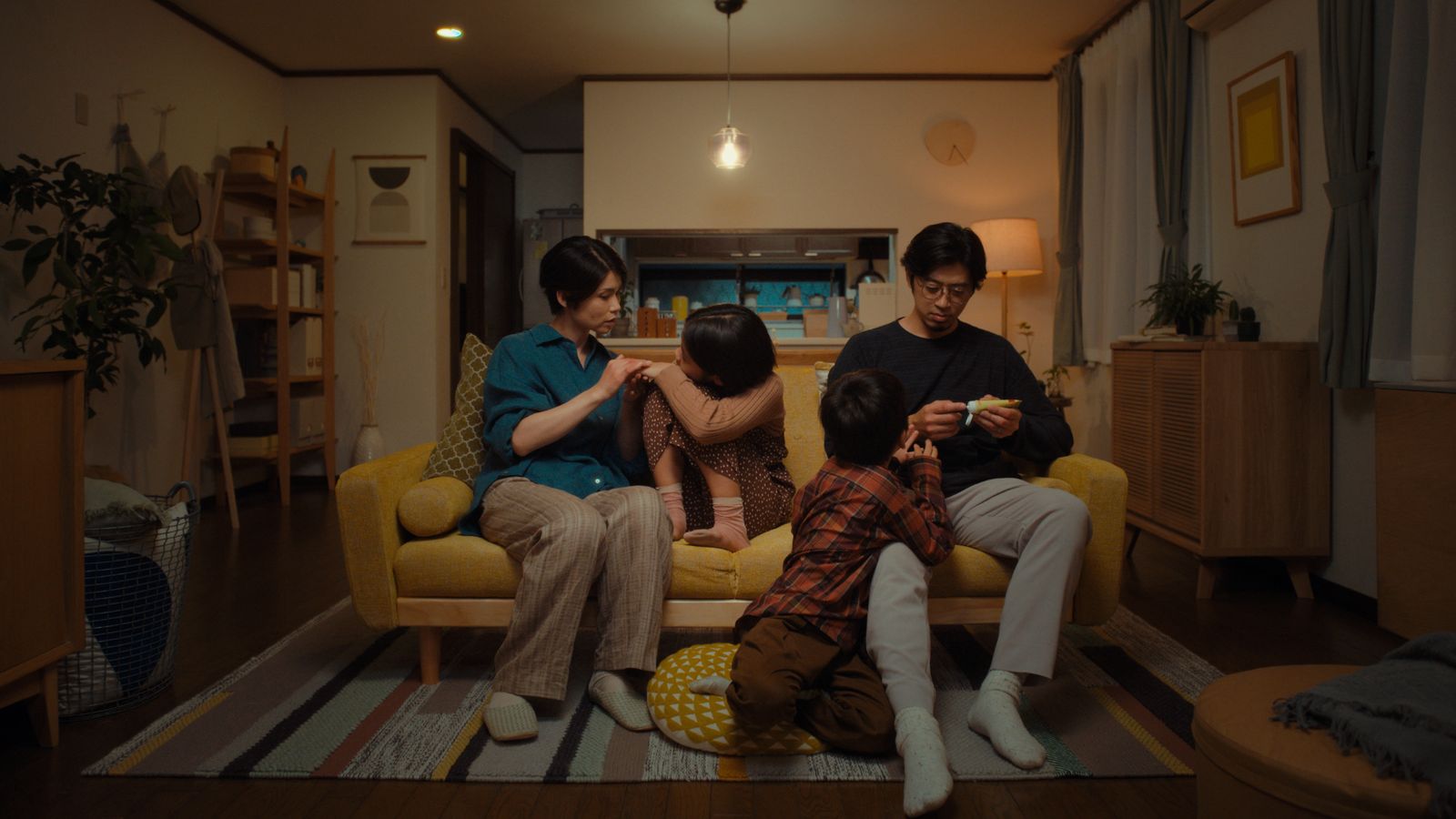 a group of people sitting on a couch in a living room