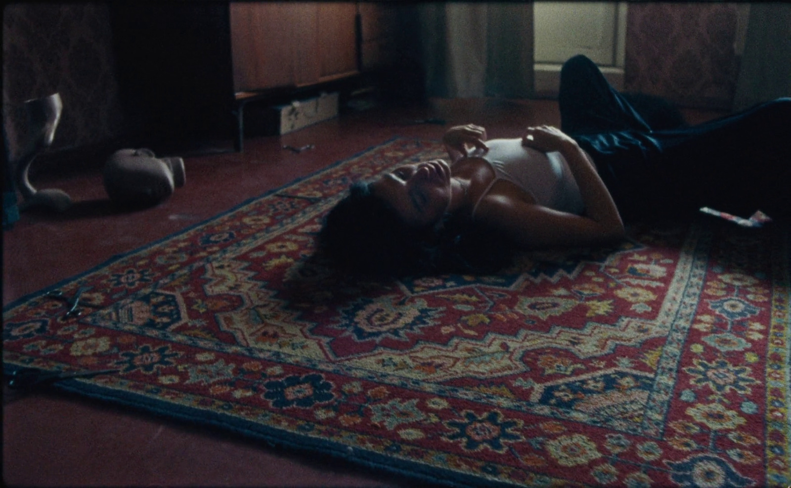 a woman laying on top of a rug on the floor