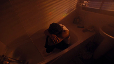 a woman sitting in a bathtub in a bathroom