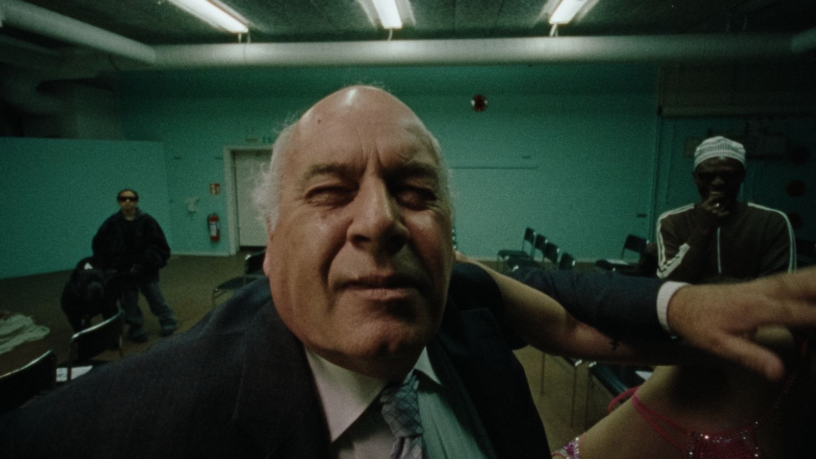 a man in a suit and tie standing in a room