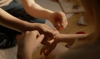 a group of people holding hands together in a circle