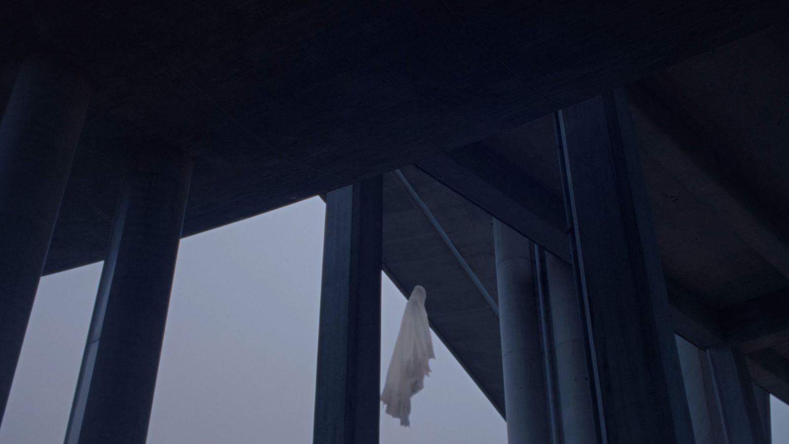 a white cloth hanging from a metal structure