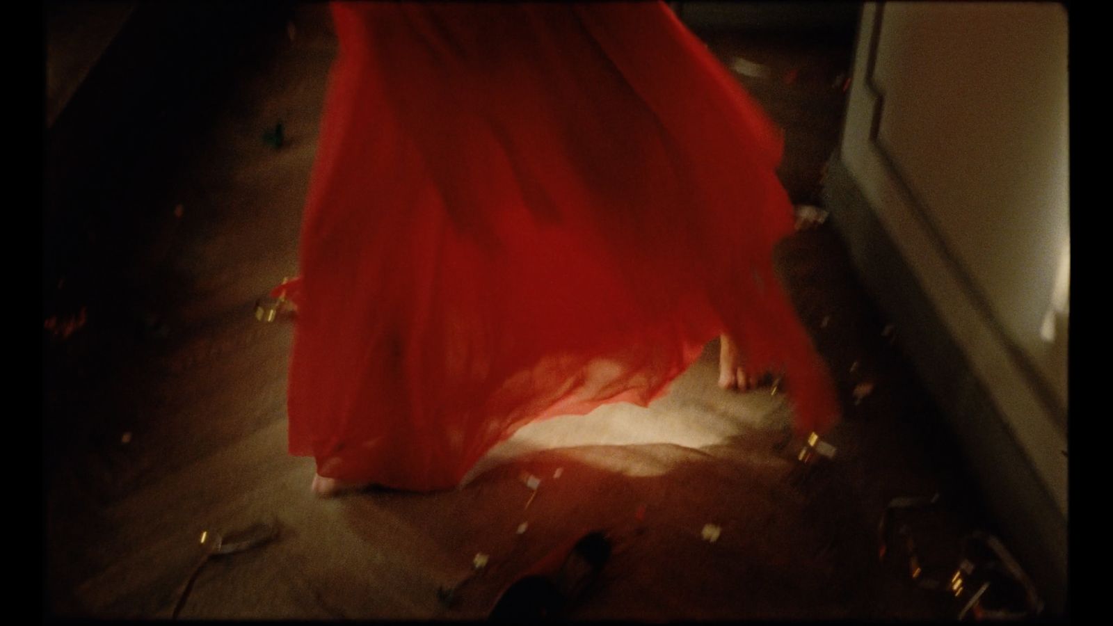 a woman in a red dress standing in a room