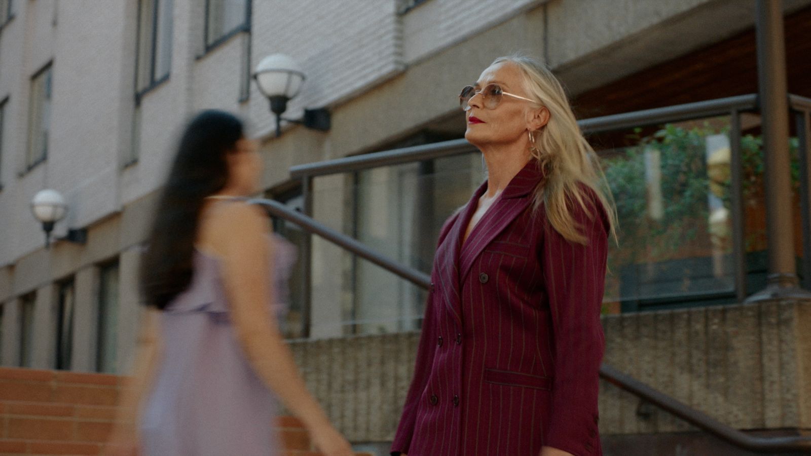 a woman in a purple dress and a woman in a purple dress walking down a