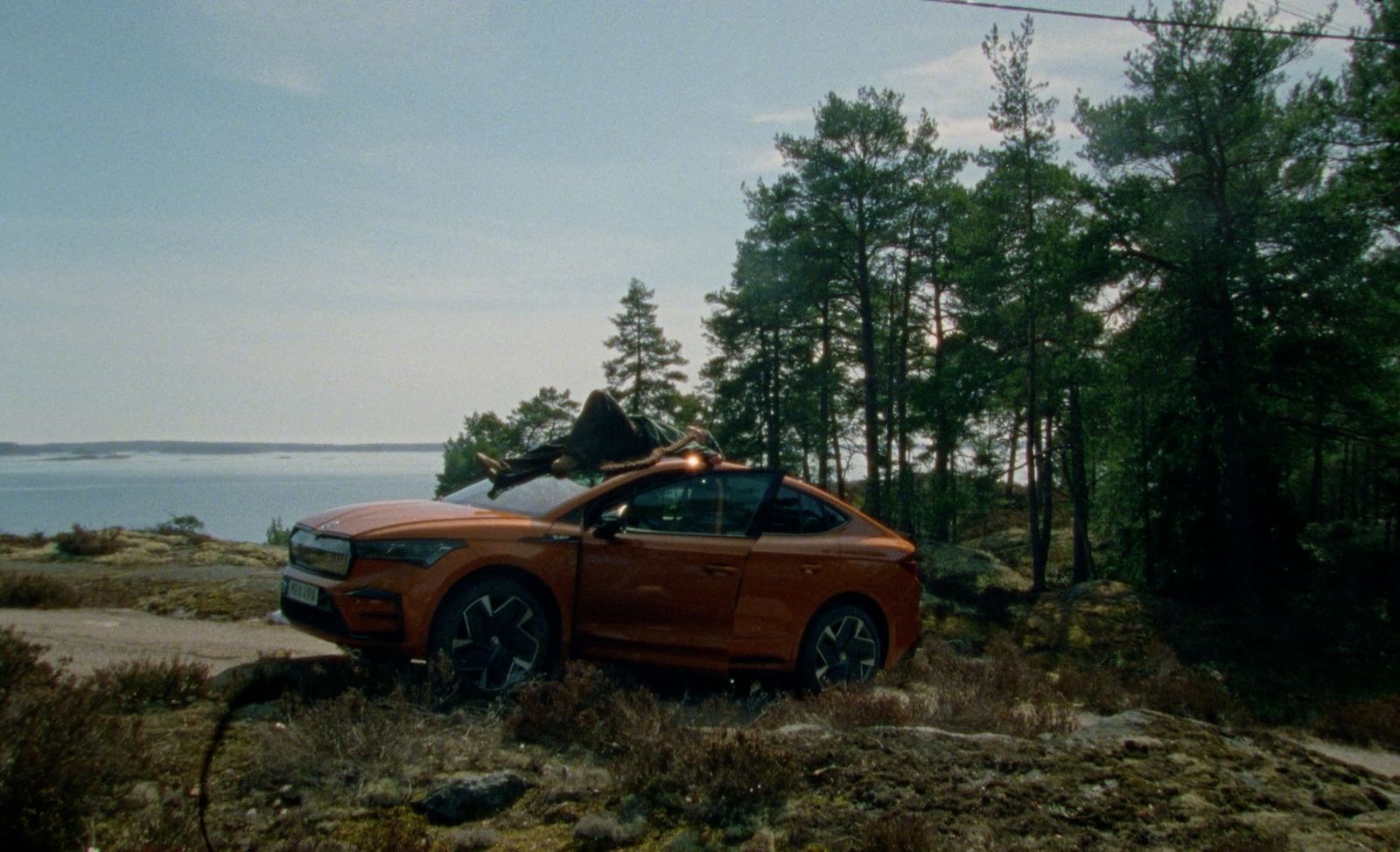 an orange car parked on the side of a road