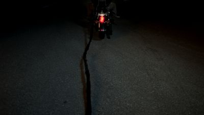 a person riding a motorcycle in the dark