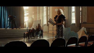 a woman standing in front of a microphone in a room