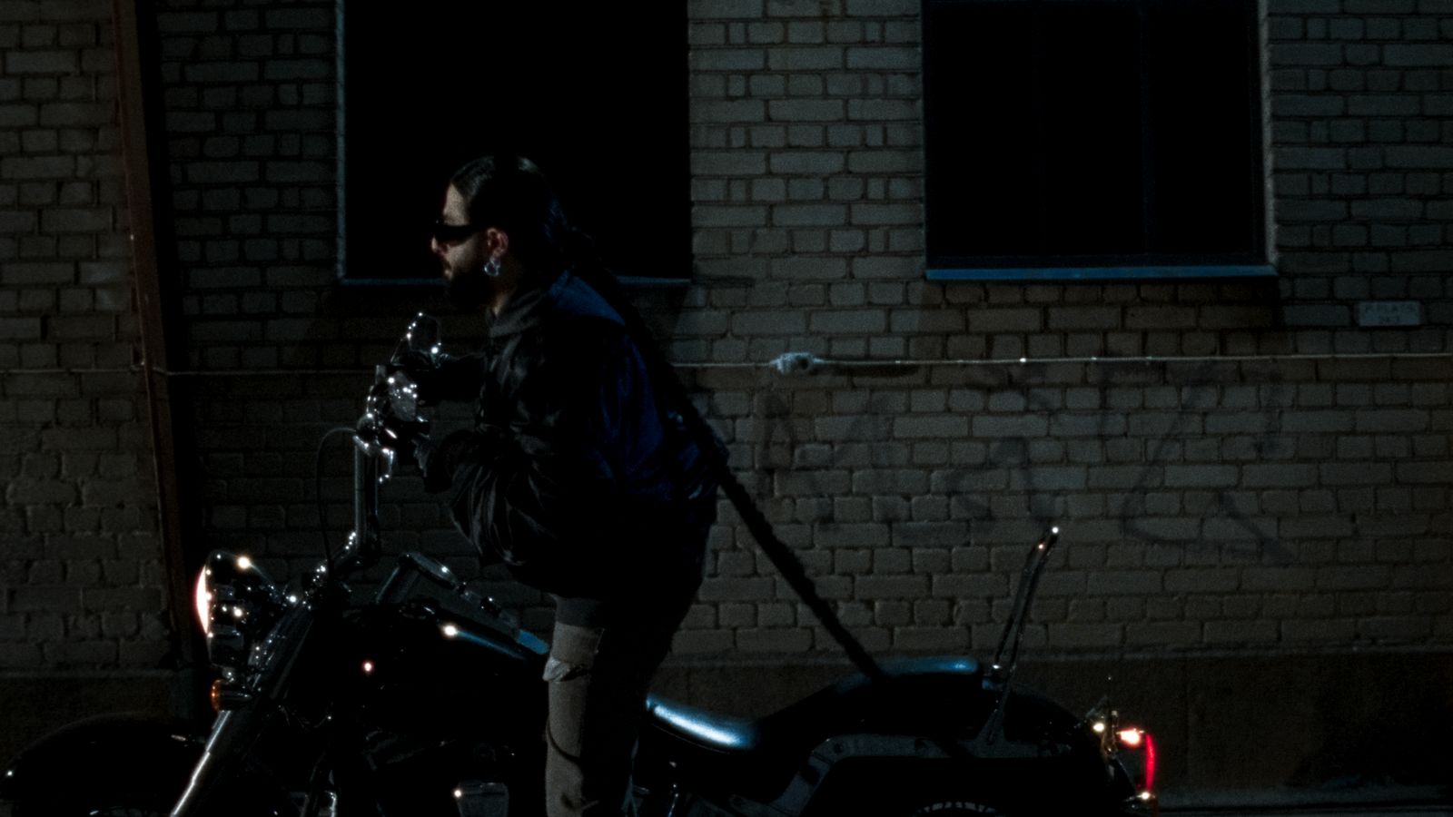 a man standing next to a parked motorcycle