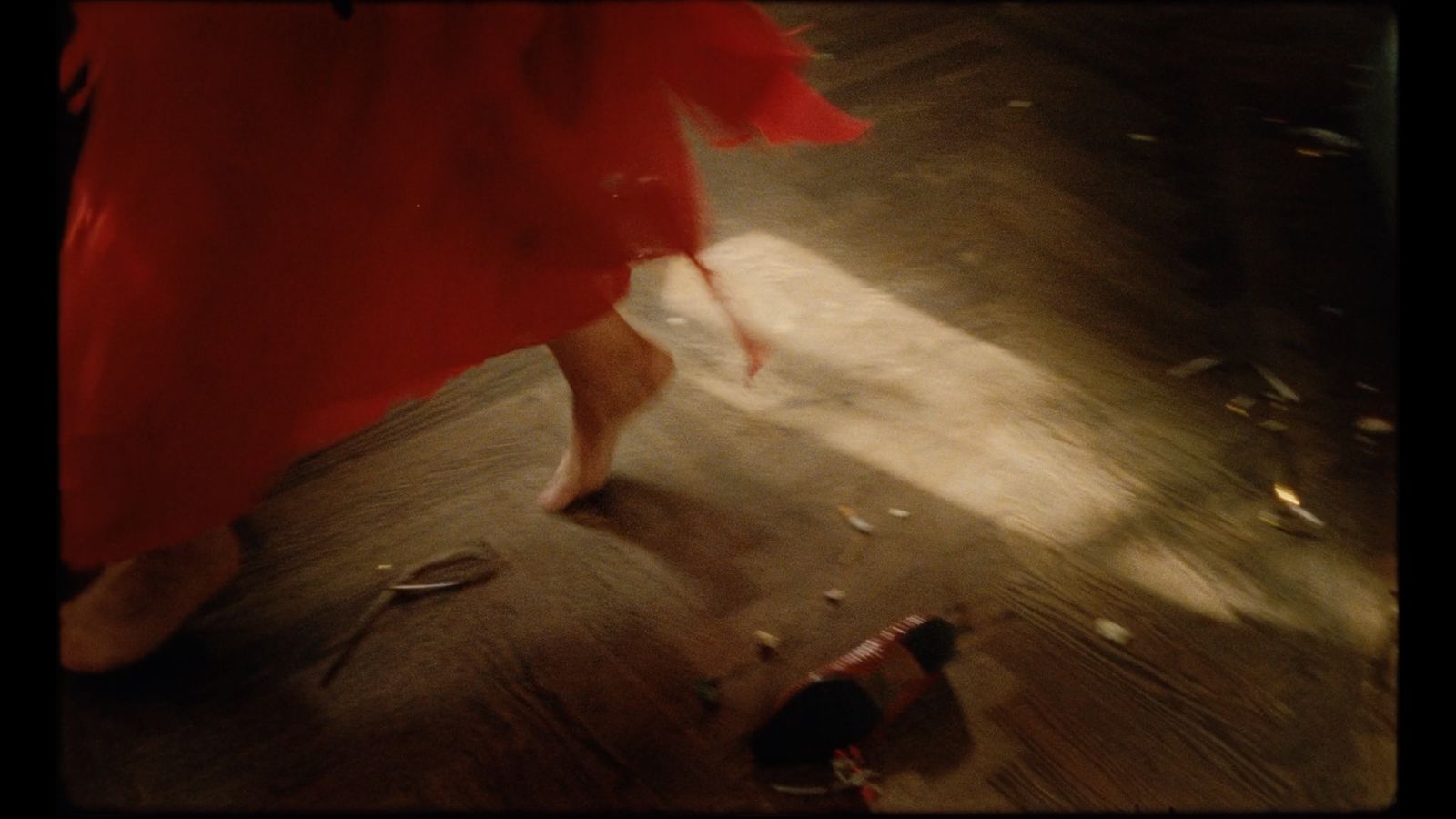 a woman in a red dress walking down a street