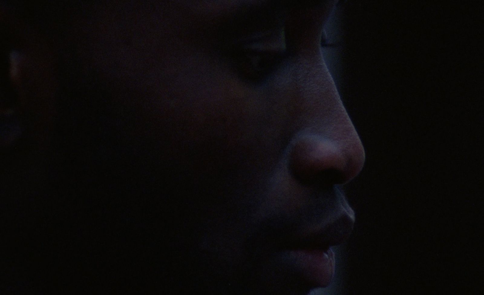 a close up of a person's face in the dark