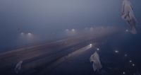 a foggy night with several people walking in the fog