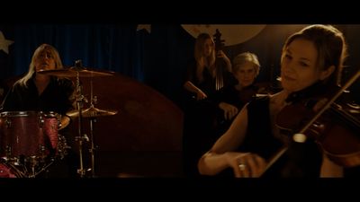 a group of women playing instruments in a room