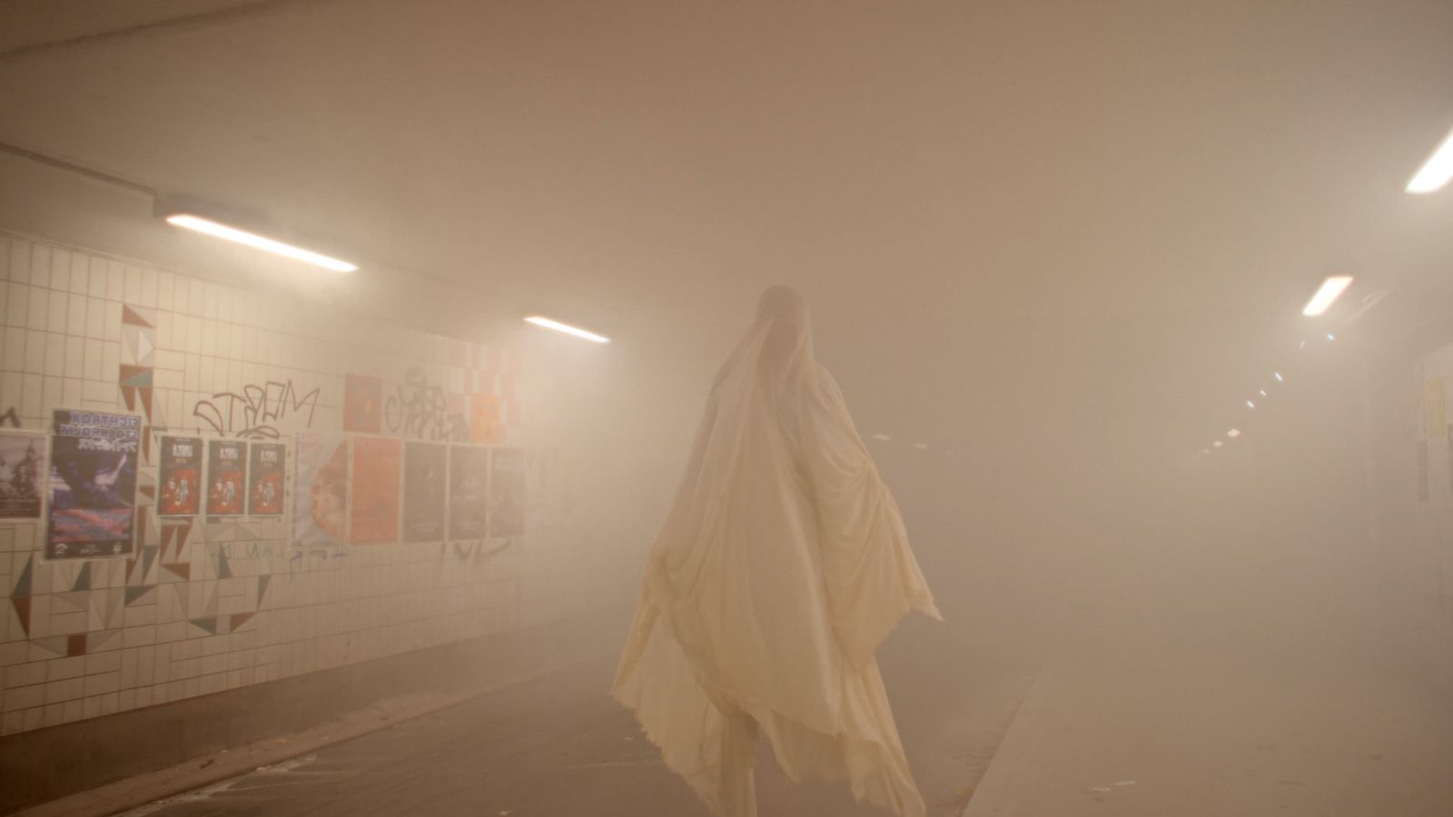 a person standing in a foggy hallway