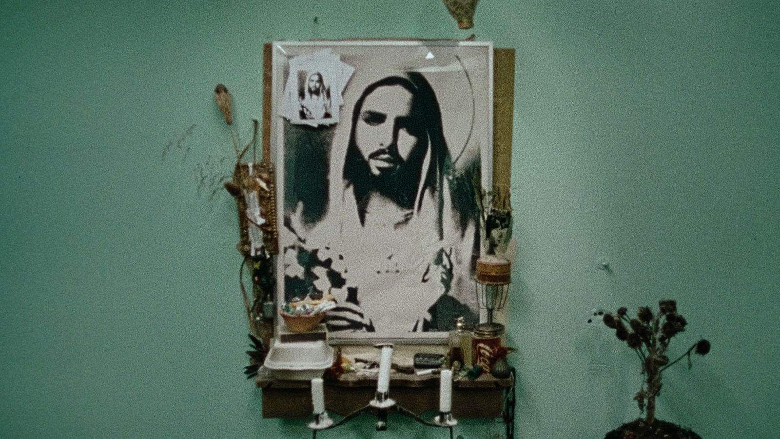 a bathroom with a picture of jesus on the wall