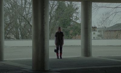 a person standing in the middle of an empty parking lot