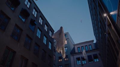 a plane is flying over a group of buildings