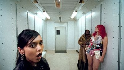 a group of women standing in a hallway next to each other