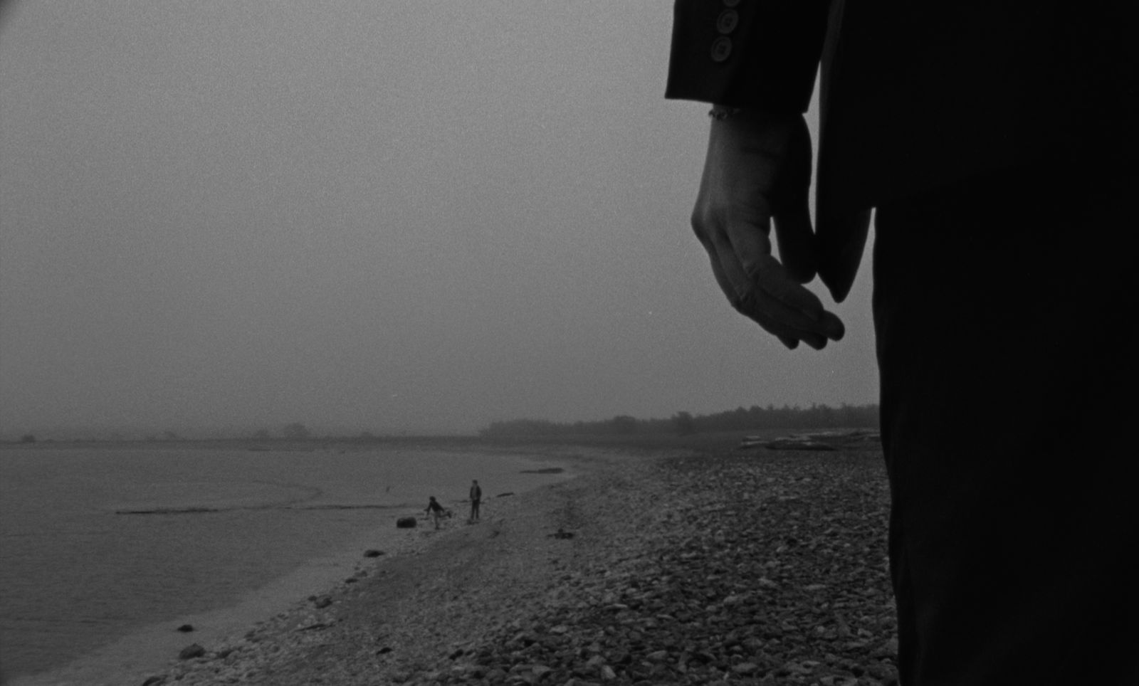 a person holding the hand of another person on a beach