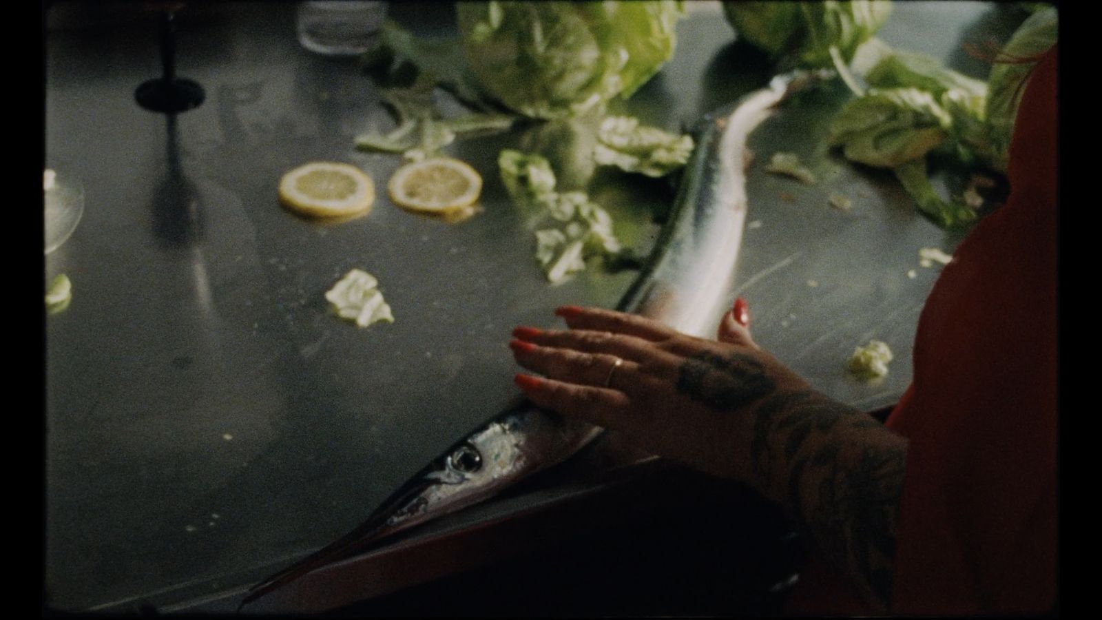 a woman is holding a fish on a table