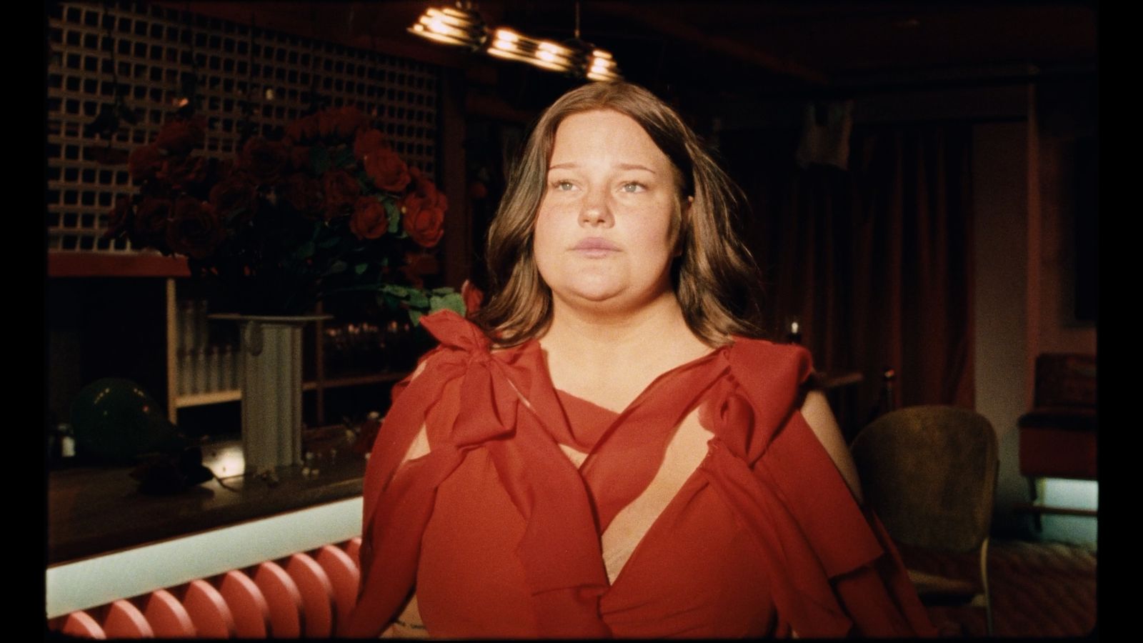 a woman in a red dress posing for a picture