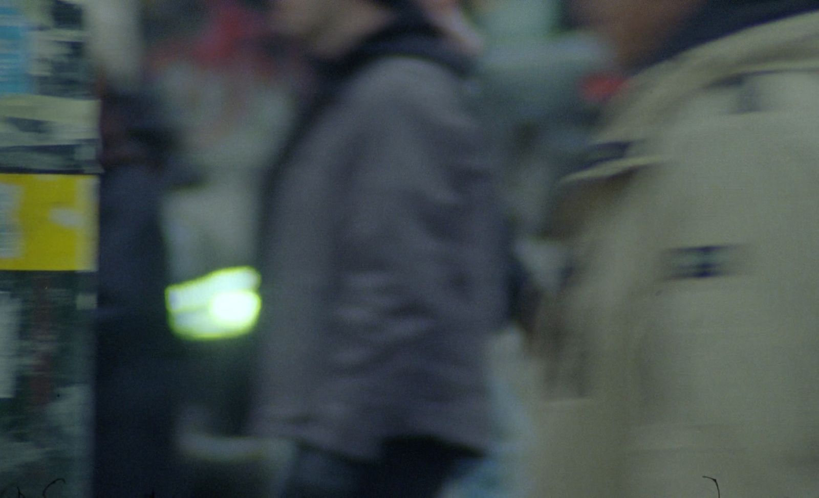 a blurry photo of a man talking on a cell phone