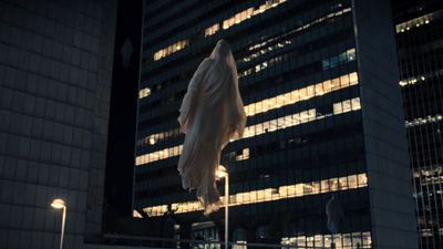 a white umbrella in front of a building at night