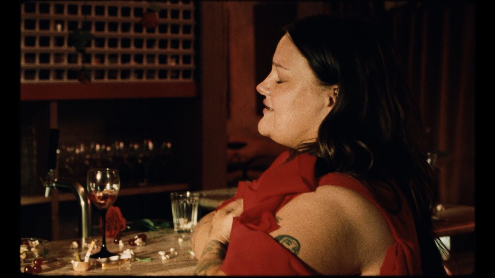 a woman in a red dress sitting at a table