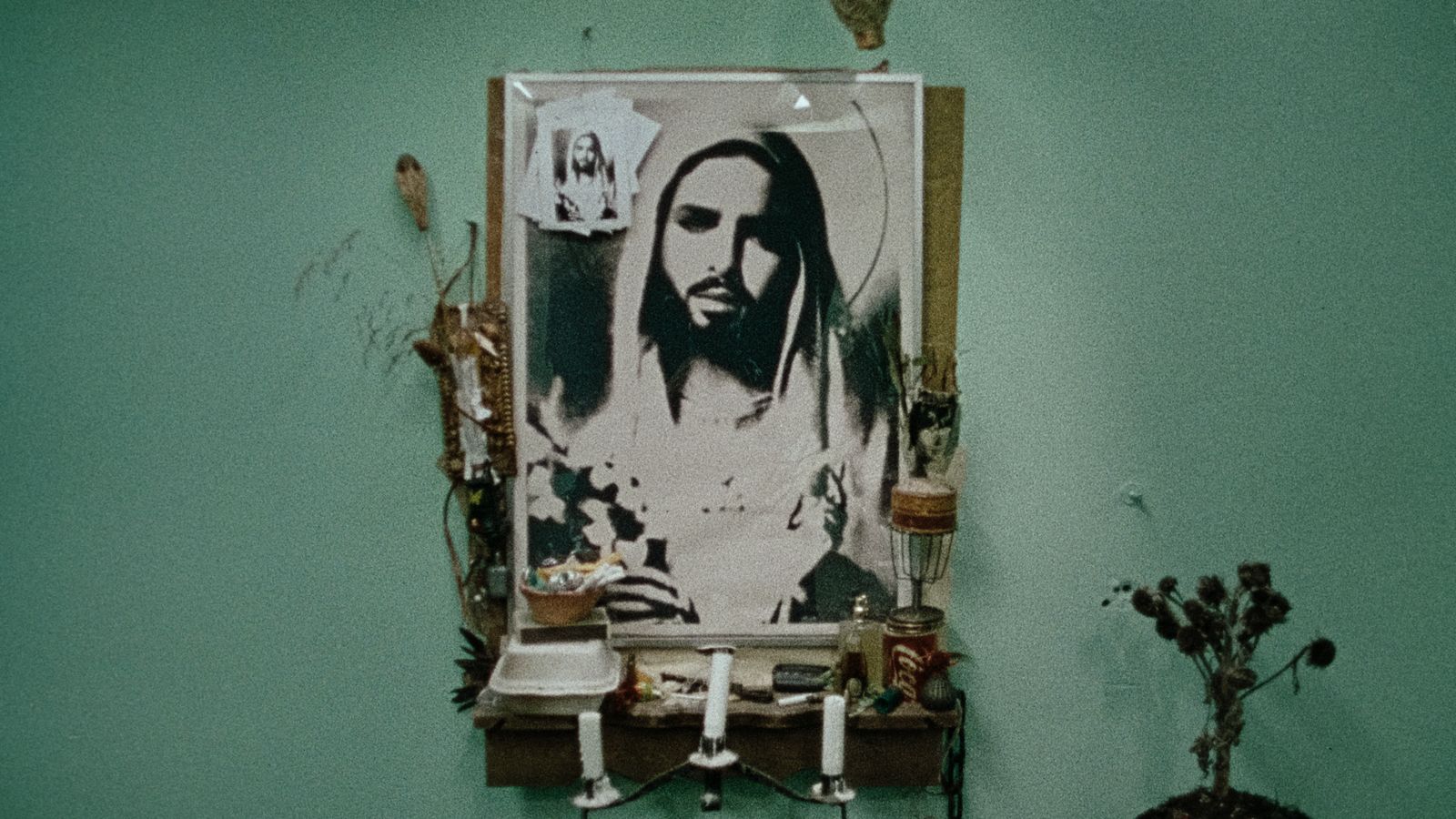 a bathroom with a picture of jesus on the wall