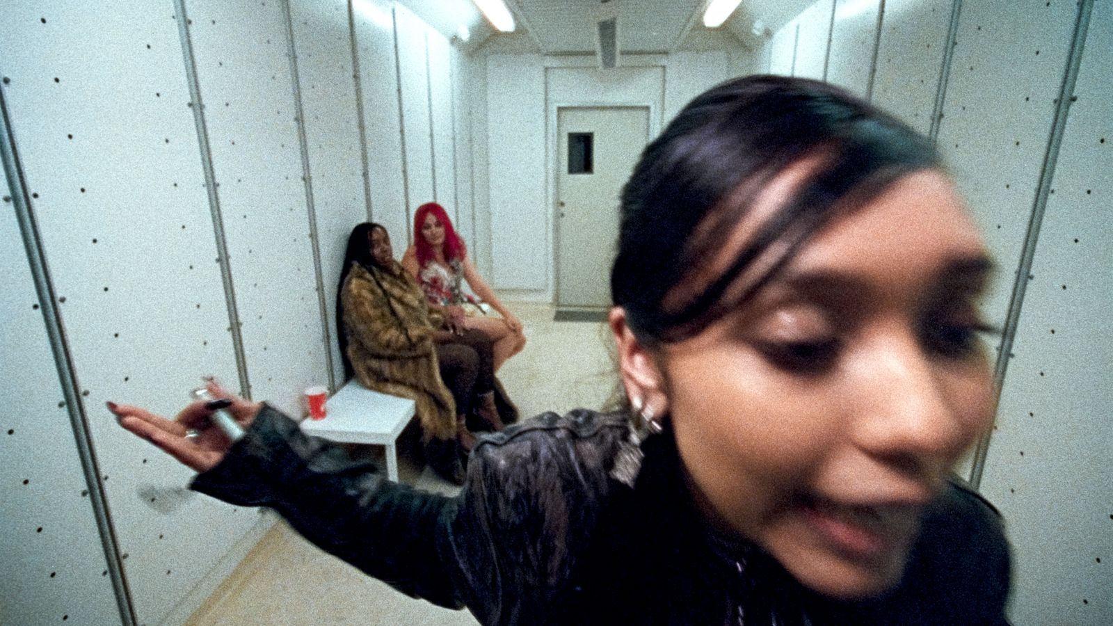 a group of women sitting on a bench in a room