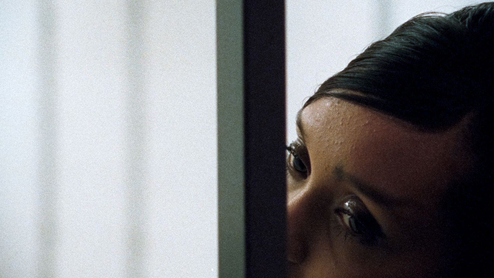 a close up of a person looking out of a window