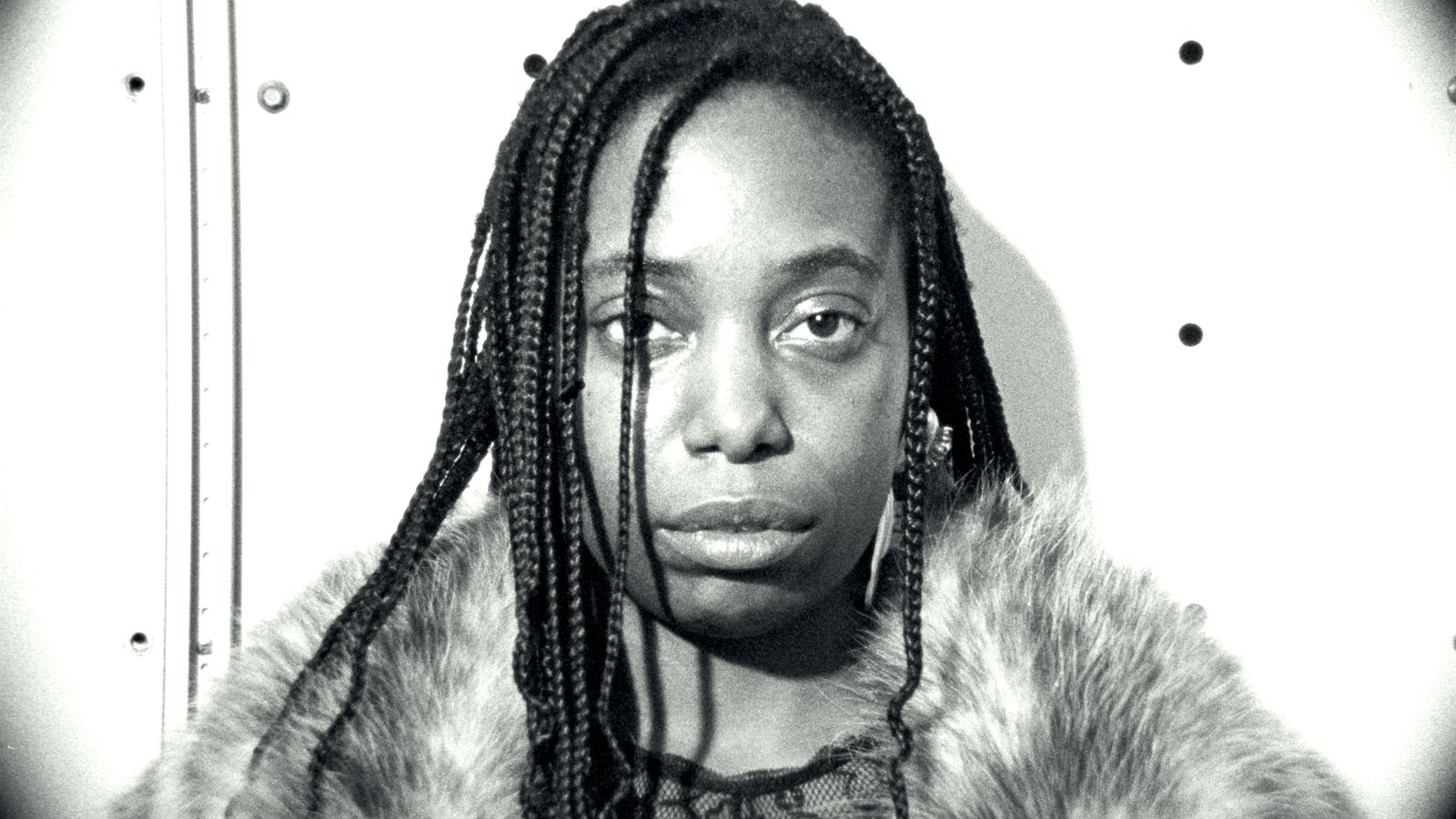 a black and white photo of a woman with dreadlocks