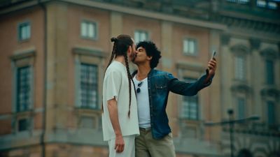 a couple of people that are standing in front of a building