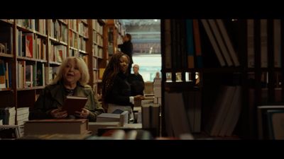 two women sitting at a table in a library