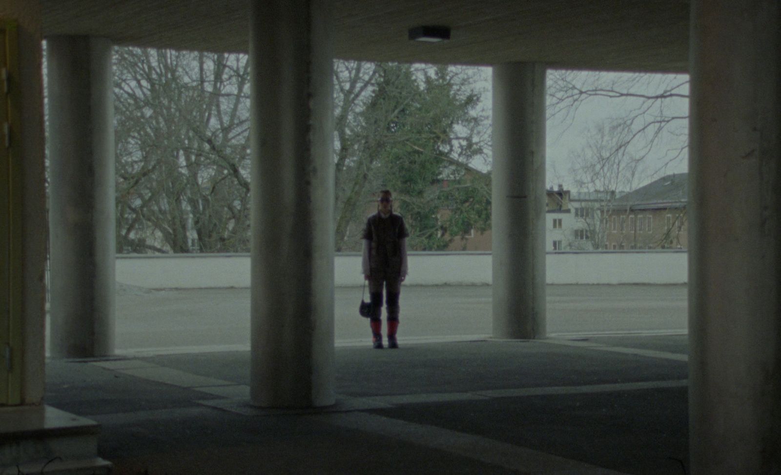 a person standing in an empty parking lot