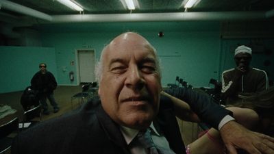 a man in a suit and tie sitting in a room