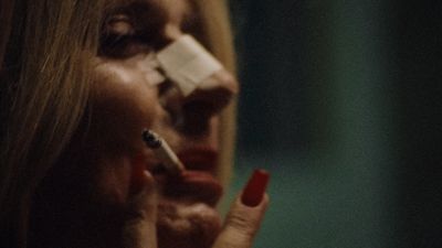 a woman with a cigarette in her mouth