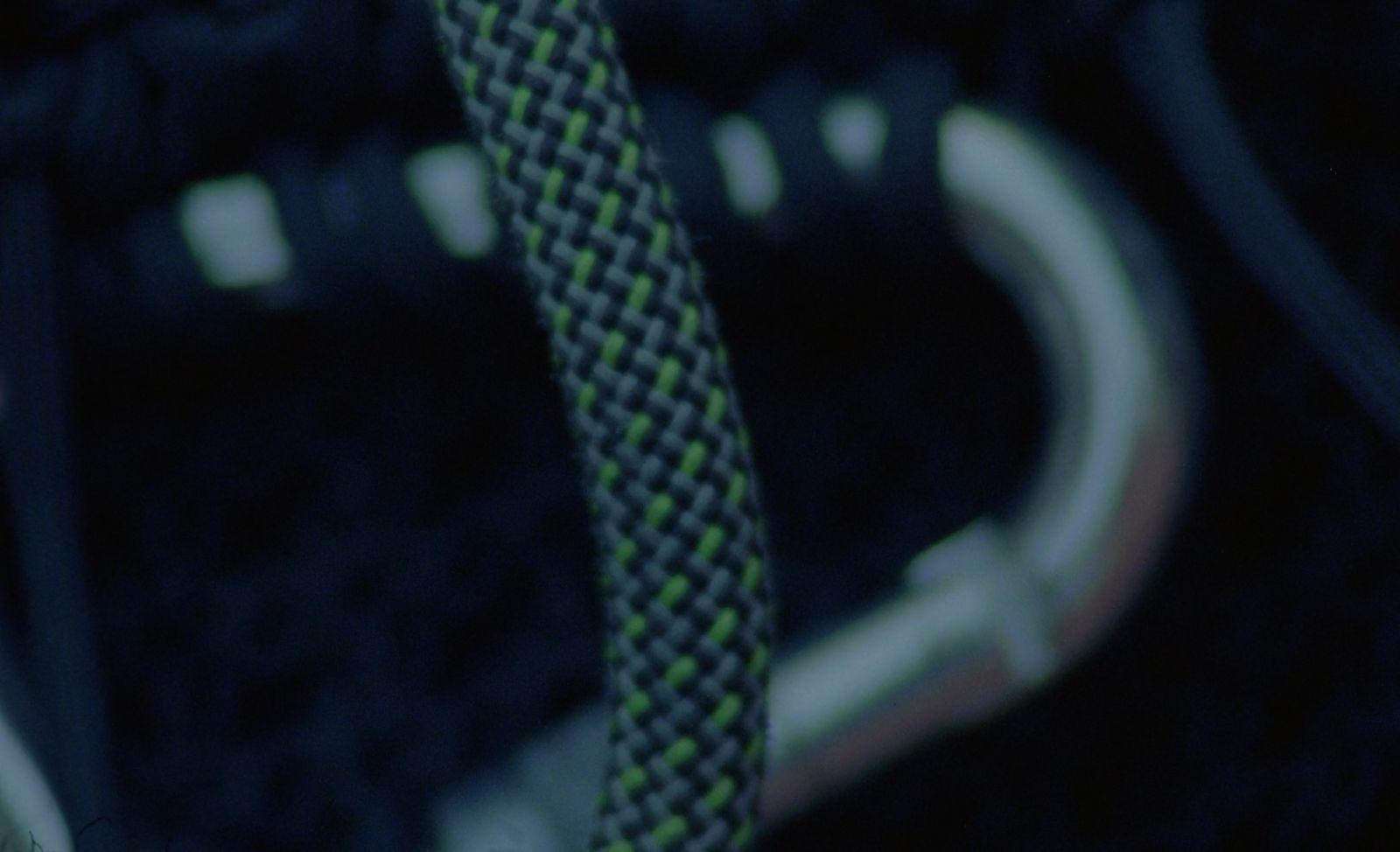 a close up of a green and black shoelace